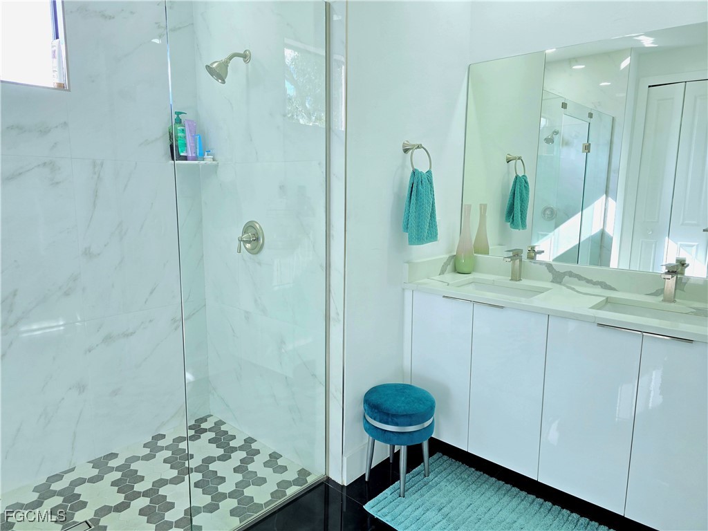 705 Harding Lane Lehigh Acres, FL 33936 - Photo 16 of 38 a bathroom with a sink a toilet and shower