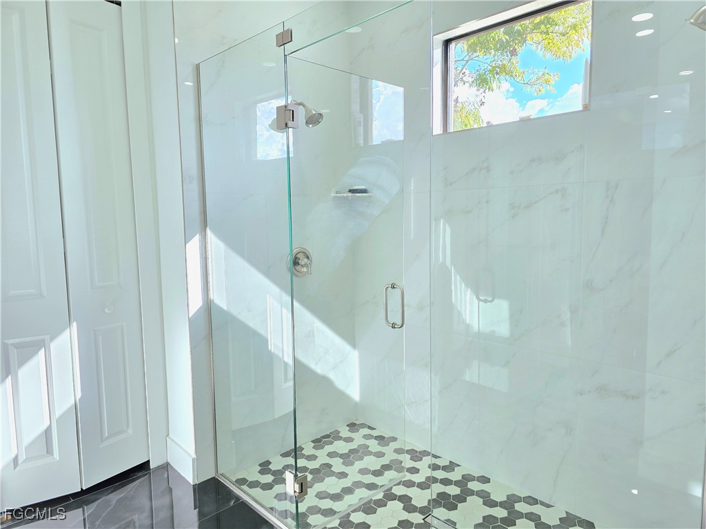 705 Harding Lane Lehigh Acres, FL 33936 - Photo 17 of 38 a bathroom with a shower and a sink