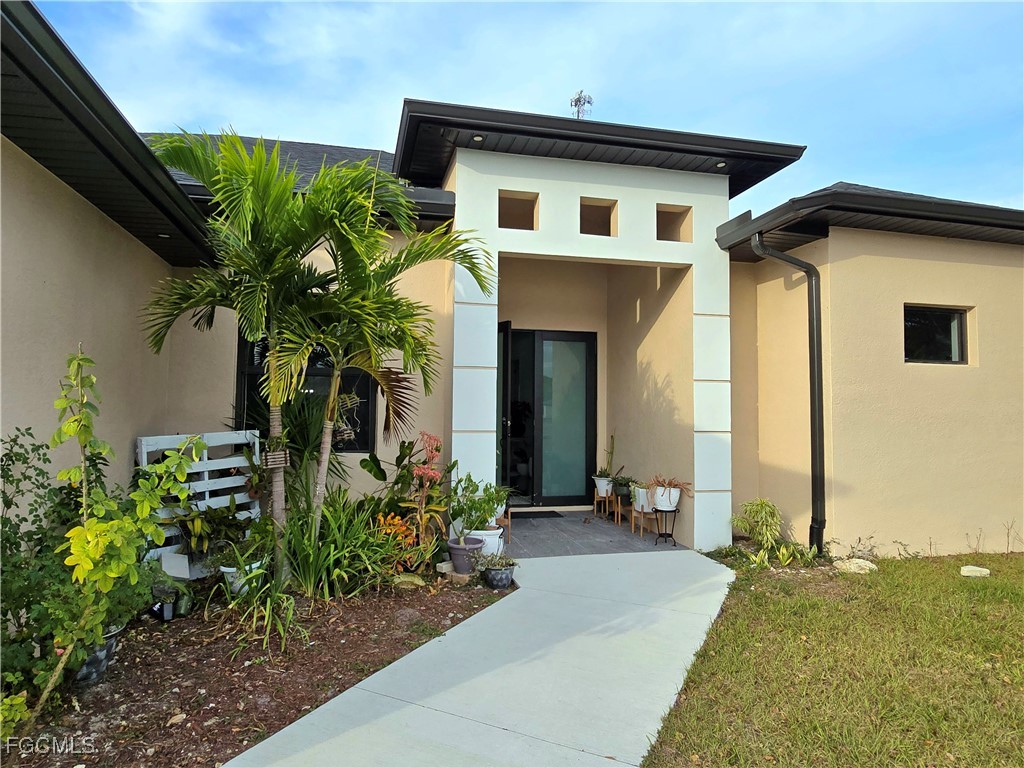 705 Harding Lane Lehigh Acres, FL 33936 - Photo 2 of 38 a front view of house with yard