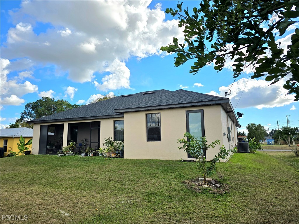 705 Harding Lane Lehigh Acres, FL 33936 - Photo 33 of 38 a front view of house with a garden