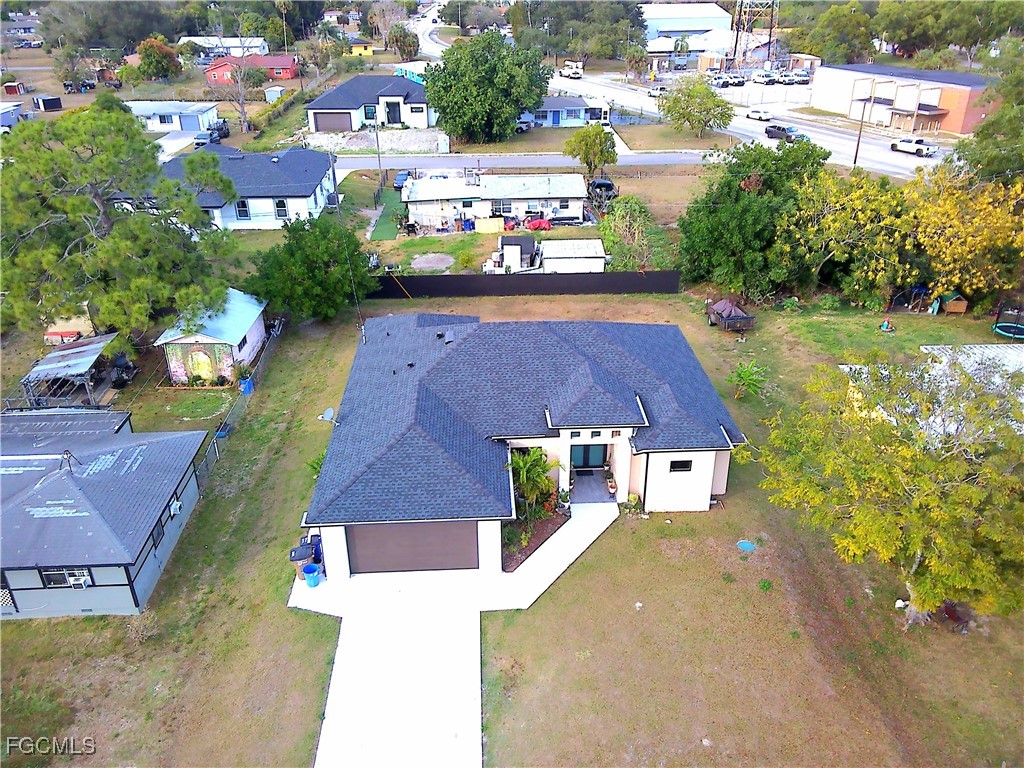 705 Harding Lane Lehigh Acres, FL 33936 - Photo 37 of 38 an aerial view of multiple houses with yard