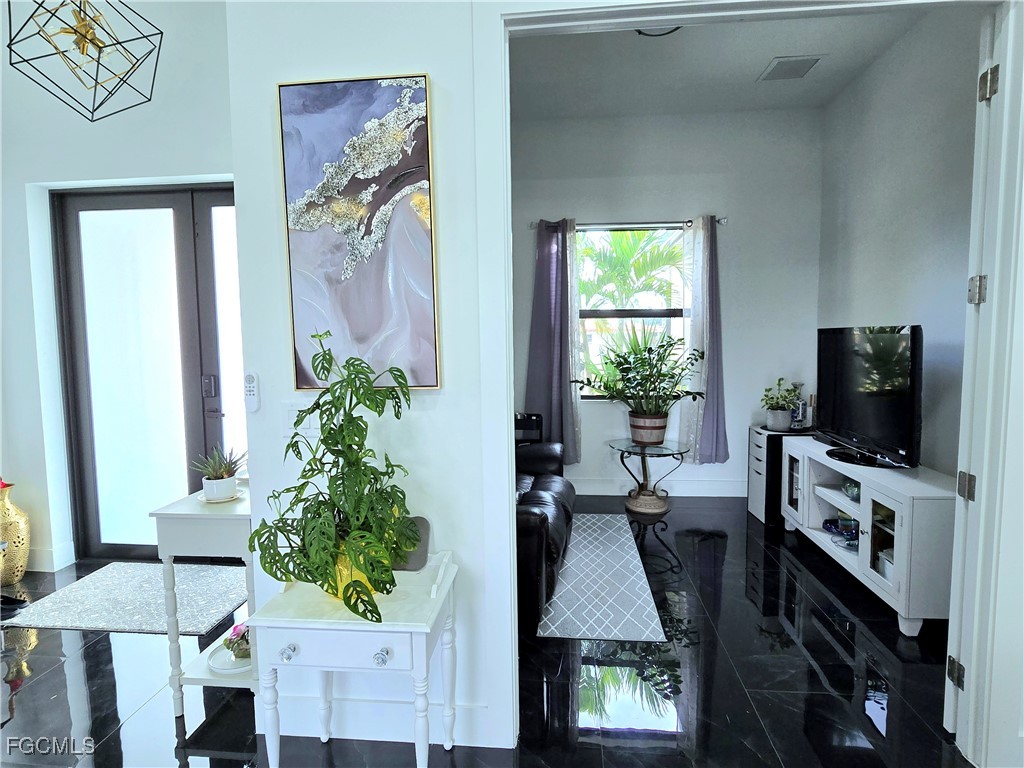 705 Harding Lane Lehigh Acres, FL 33936 - Photo 5 of 38 a living room with furniture and a flat screen tv
