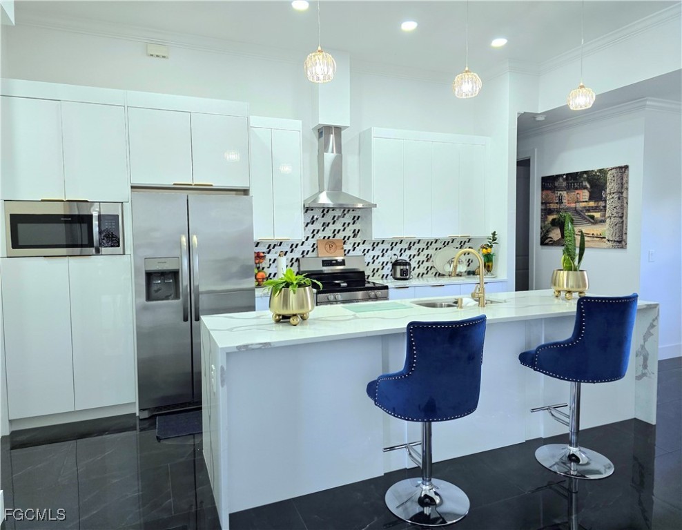 705 Harding Lane Lehigh Acres, FL 33936 - Photo 6 of 38 a kitchen with stainless steel appliances kitchen island granite countertop a refrigerator and a stove top oven