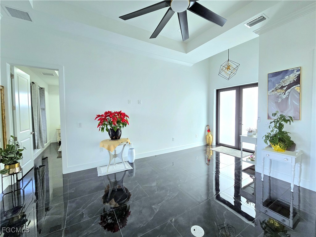 705 Harding Lane Lehigh Acres, FL 33936 - Photo 7 of 38 a vase of flowers sitting on a table with a potted plant