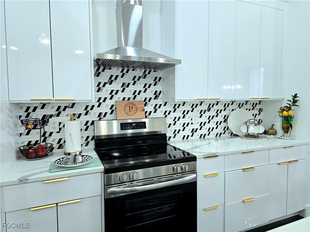 705 Harding Lane Lehigh Acres, FL 33936 - Photo 8 of 38 a kitchen with a stove and cabinets