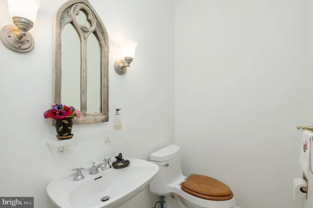 a bathroom with a toilet sink and mirror