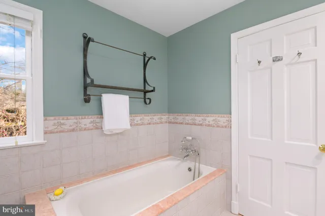 a bathroom with a bathtub and shower