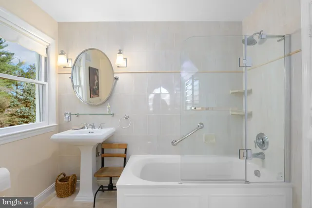 a bathroom with a sink a bathtub and a mirror