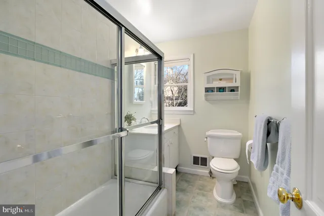 a white toilet sitting next to a bathroom sink