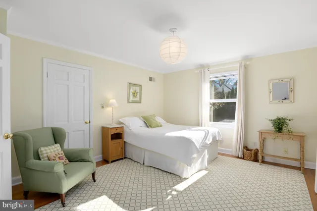 a bedroom with a bed and a couch