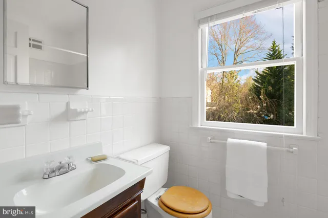 a white toilet sitting next to a bathroom sink