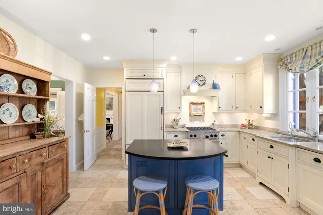 a kitchen with stainless steel appliances a sink stove and cabinets