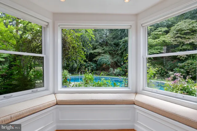 a view of a room that has a window and front door