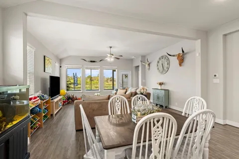 a view of a a dining room with furniture window and wooden floor