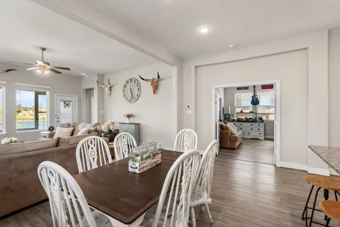 a dining room with furniture and wooden floor