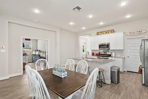 a kitchen with stainless steel appliances kitchen island granite countertop a stove and a sink