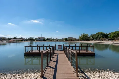 an aerial view of a swimming pool with outdoor seating