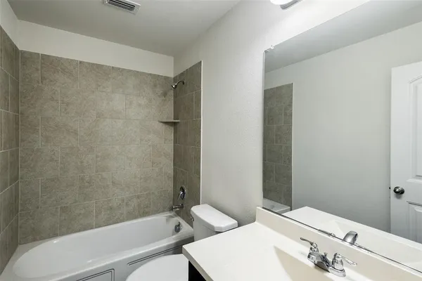 a bathroom with a bathtub and sink
