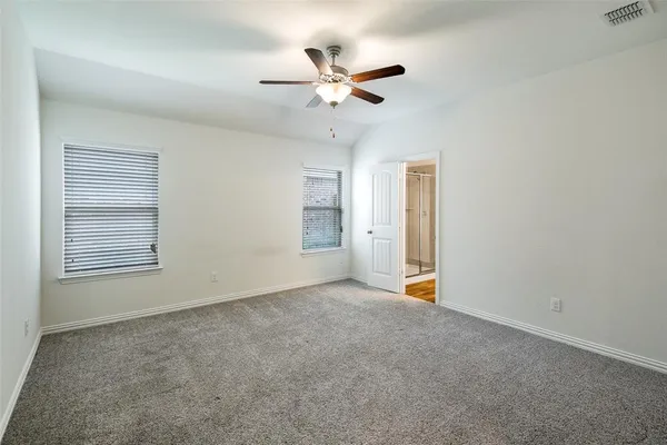 a view of an empty room with a ceiling fan