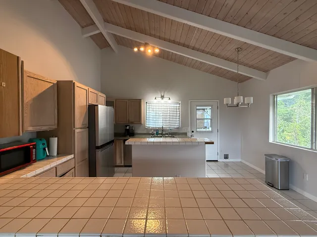 a kitchen with stainless steel appliances a refrigerator and a stove top oven