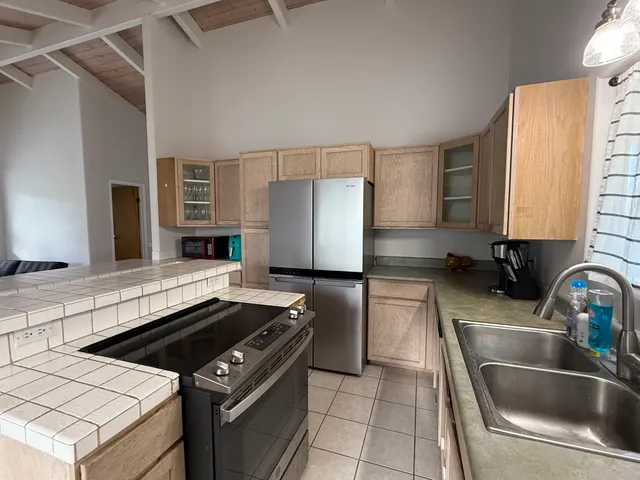 a kitchen with a stove a sink and a refrigerator