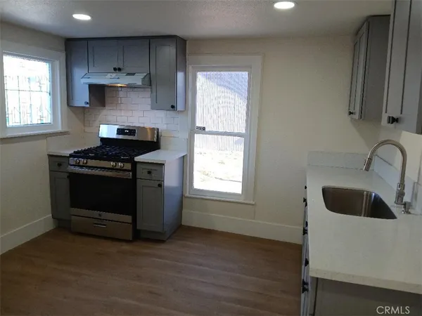 a kitchen with wooden cabinets and a stove top oven