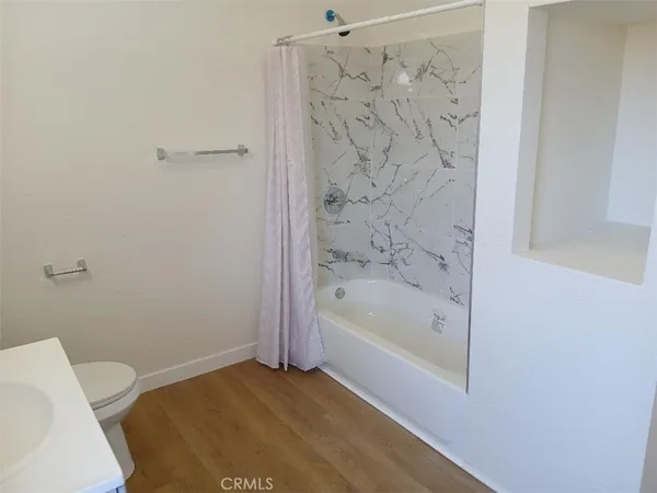 a bathroom with a bathtub and toilet