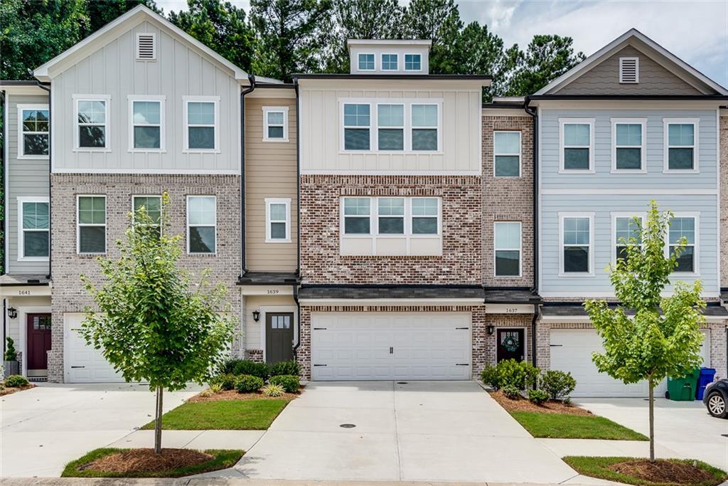 1639 Venture Pt Way Decatur, GA 30032 - Photo 1 of 1 a front view of a house with a yard and garage