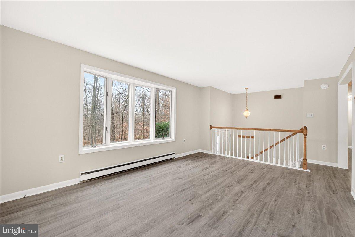 9505 Cabbage Run Road Frederick, MD 21701 - Photo 11 of 50 a view of an empty room with wooden floor and a window