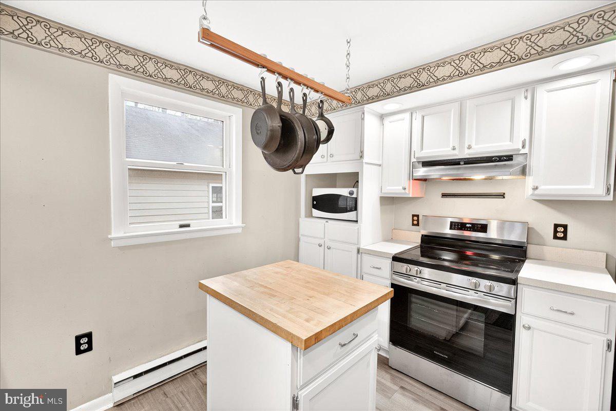 9505 Cabbage Run Road Frederick, MD 21701 - Photo 17 of 50 a kitchen with stainless steel appliances a stove a microwave and a window