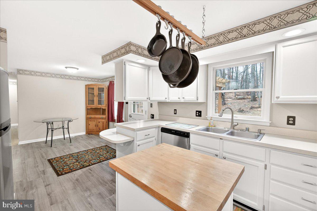 9505 Cabbage Run Road Frederick, MD 21701 - Photo 19 of 50 a kitchen with a stove a sink and a dining table