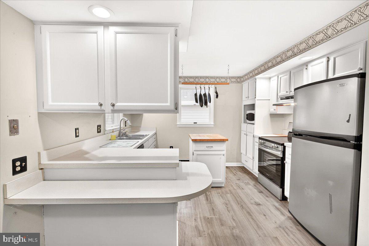 9505 Cabbage Run Road Frederick, MD 21701 - Photo 20 of 50 a kitchen with a refrigerator sink stove and cabinets
