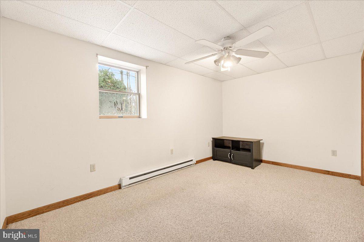 9505 Cabbage Run Road Frederick, MD 21701 - Photo 31 of 50 an empty room with a ceiling fan and wooden floor