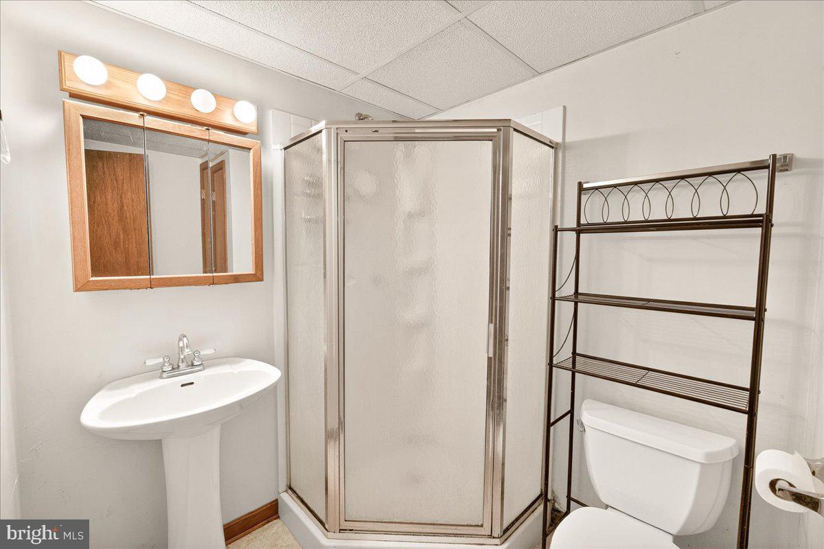 9505 Cabbage Run Road Frederick, MD 21701 - Photo 32 of 50 a bathroom with a shower sink and mirror