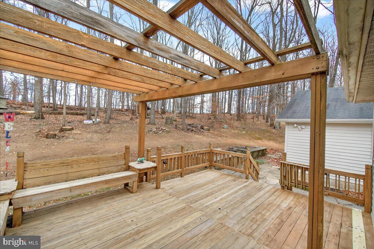 9505 Cabbage Run Road Frederick, MD 21701 - Photo 37 of 50 a view of a patio with a table chairs and wooden floor