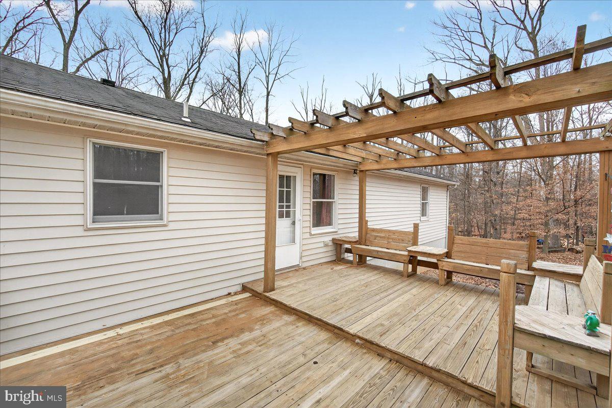 9505 Cabbage Run Road Frederick, MD 21701 - Photo 38 of 50 a view of a white house with a wooden bench