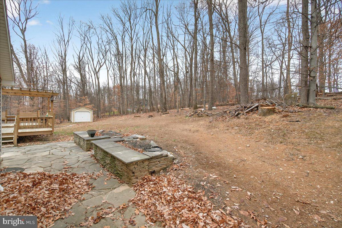 9505 Cabbage Run Road Frederick, MD 21701 - Photo 40 of 50 a backyard of a house with barbeque oven table and chairs