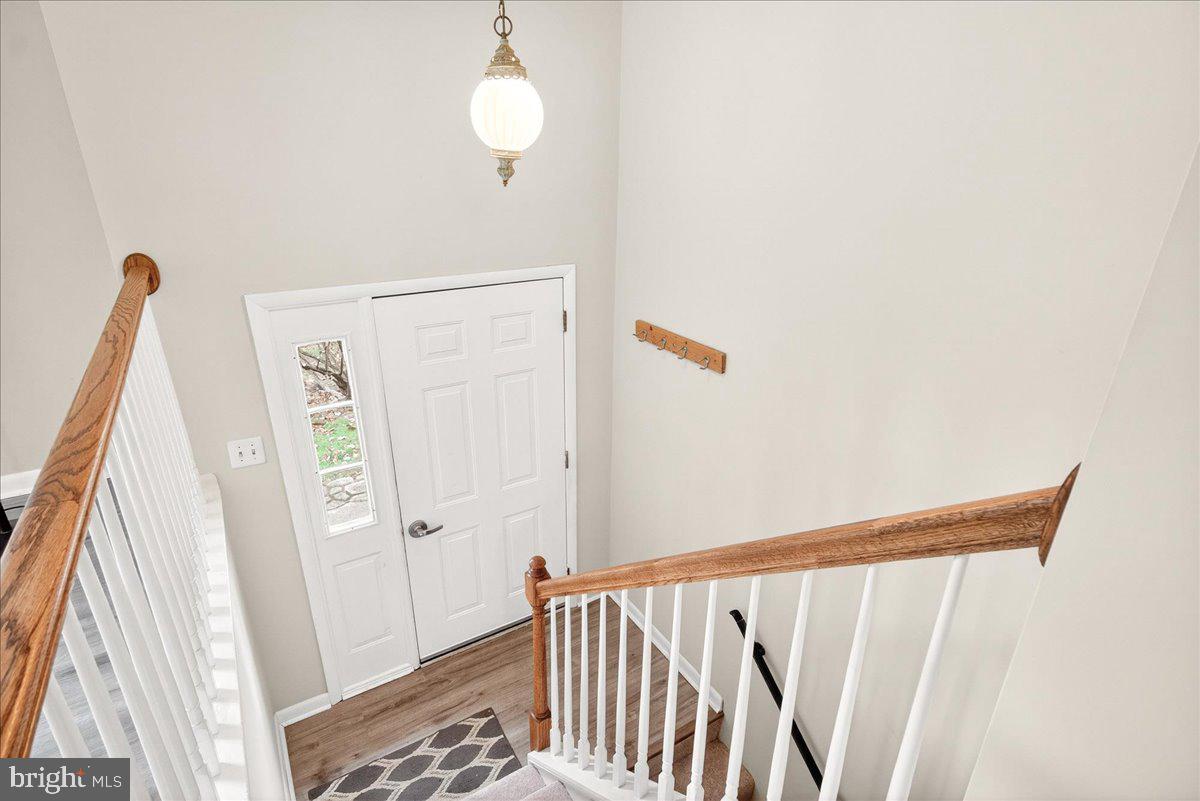 9505 Cabbage Run Road Frederick, MD 21701 - Photo 9 of 50 a view of a hallway with wooden floor and stairs
