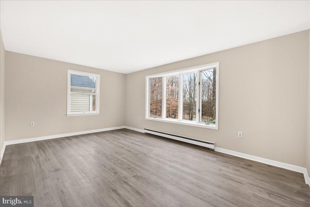 9505 Cabbage Run Road Frederick, MD 21701 - Photo 10 of 50 an empty room with wooden floor and windows