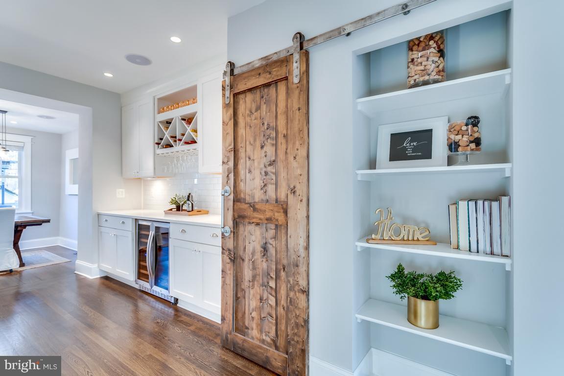 2211 38th Street Northwest Washington, DC 20007 - Photo 11 of 51 a living room with stainless steel appliances kitchen island a refrigerator and a wooden floor