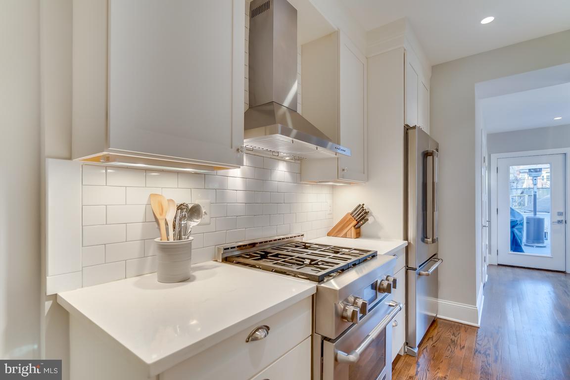 2211 38th Street Northwest Washington, DC 20007 - Photo 13 of 51 a kitchen with a stove and a wooden floor