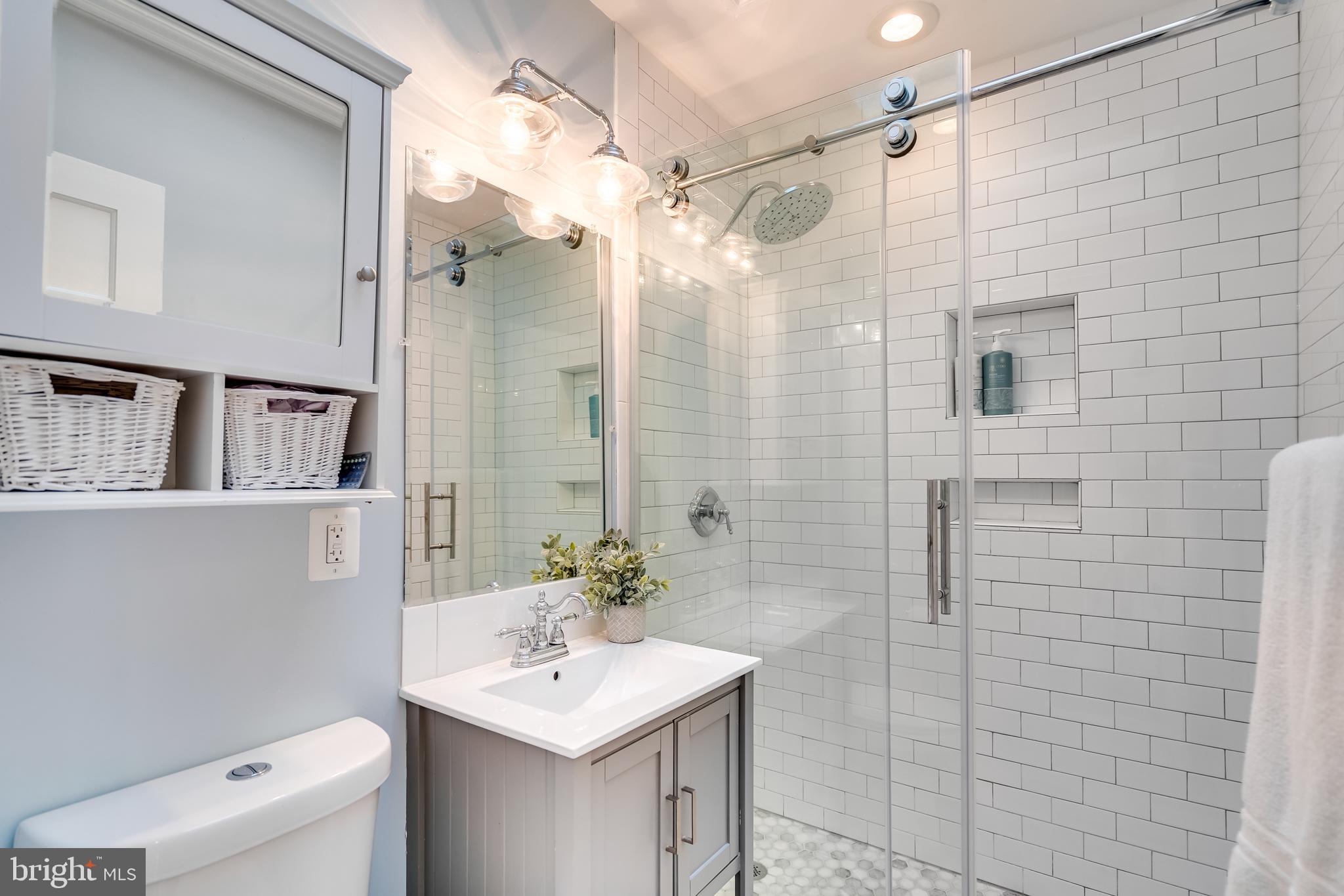 2211 38th Street Northwest Washington, DC 20007 - Photo 22 of 51 a bathroom with a sink a toilet and shower