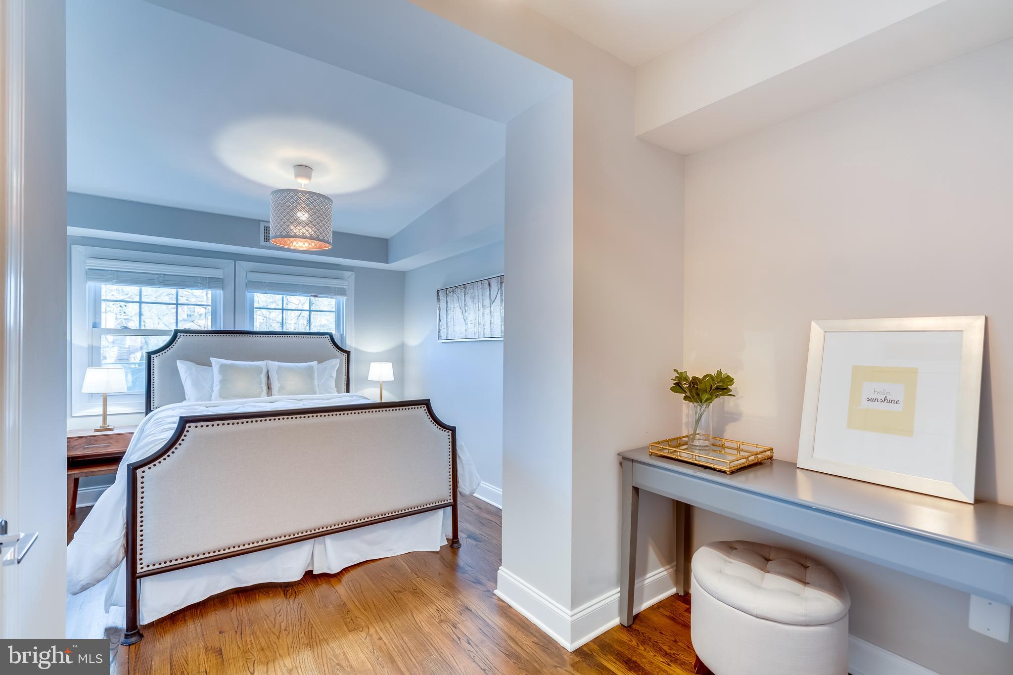 2211 38th Street Northwest Washington, DC 20007 - Photo 23 of 51 a living room with a bed and a chandelier