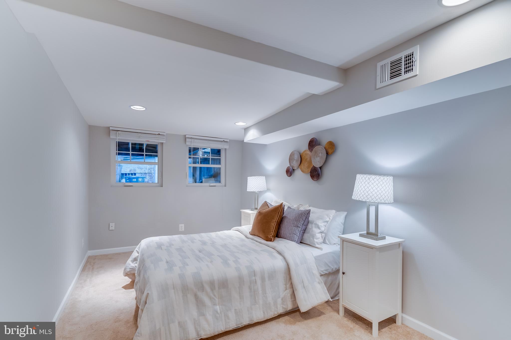 2211 38th Street Northwest Washington, DC 20007 - Photo 31 of 51 a bedroom with a bed and a lamp
