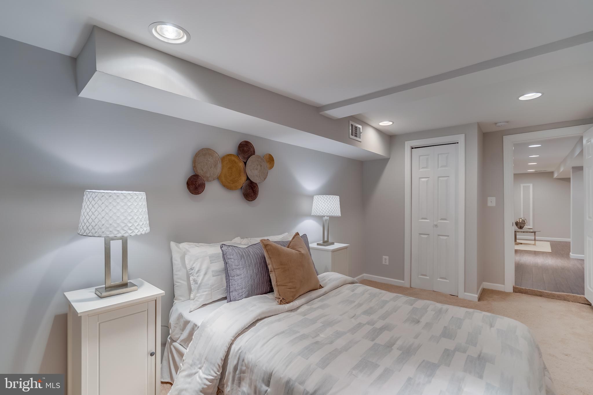 2211 38th Street Northwest Washington, DC 20007 - Photo 32 of 51 a bedroom with a bed and a lamp