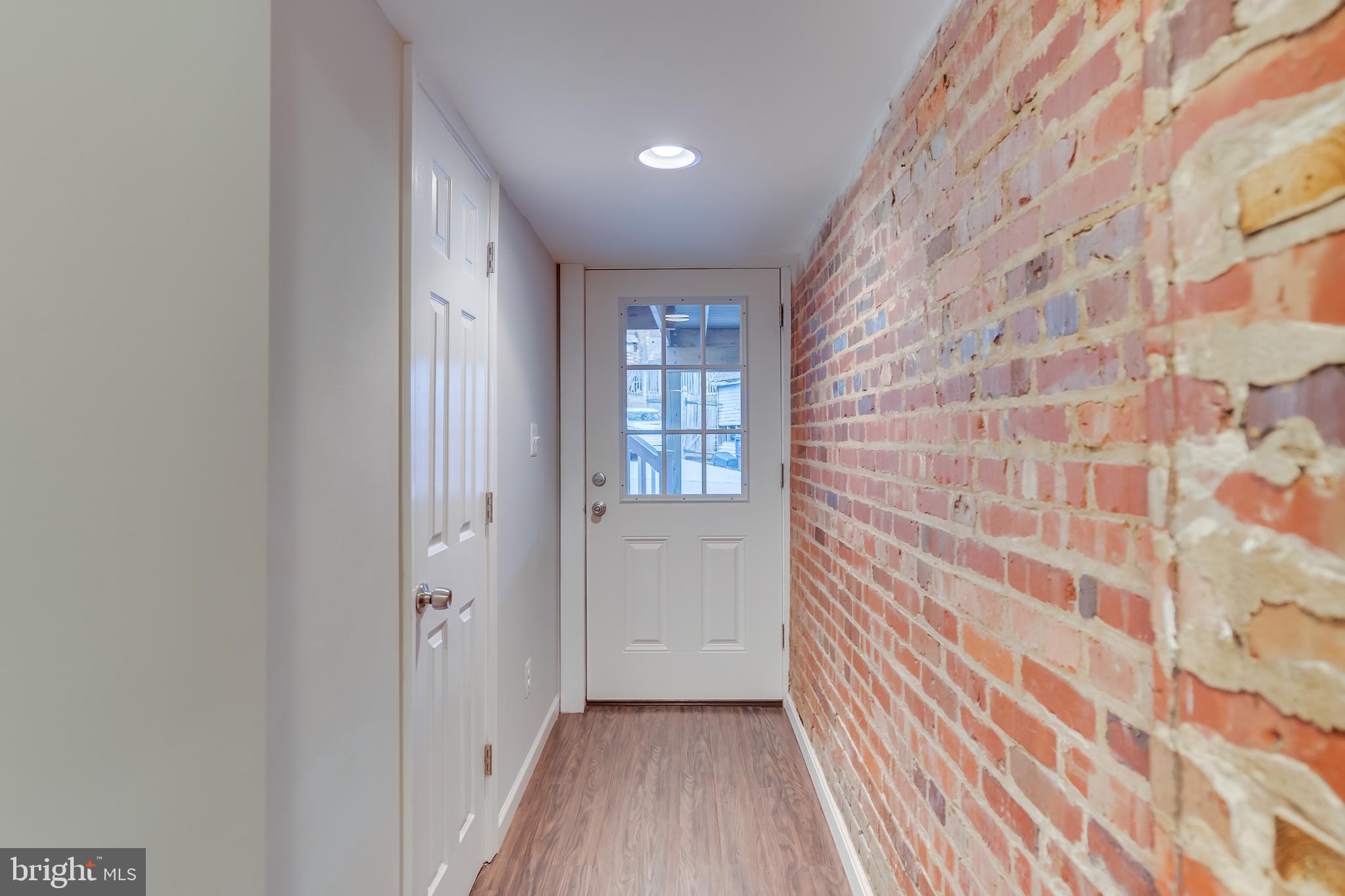 2211 38th Street Northwest Washington, DC 20007 - Photo 35 of 51 a view of a hallway with wooden floor and a bathroom