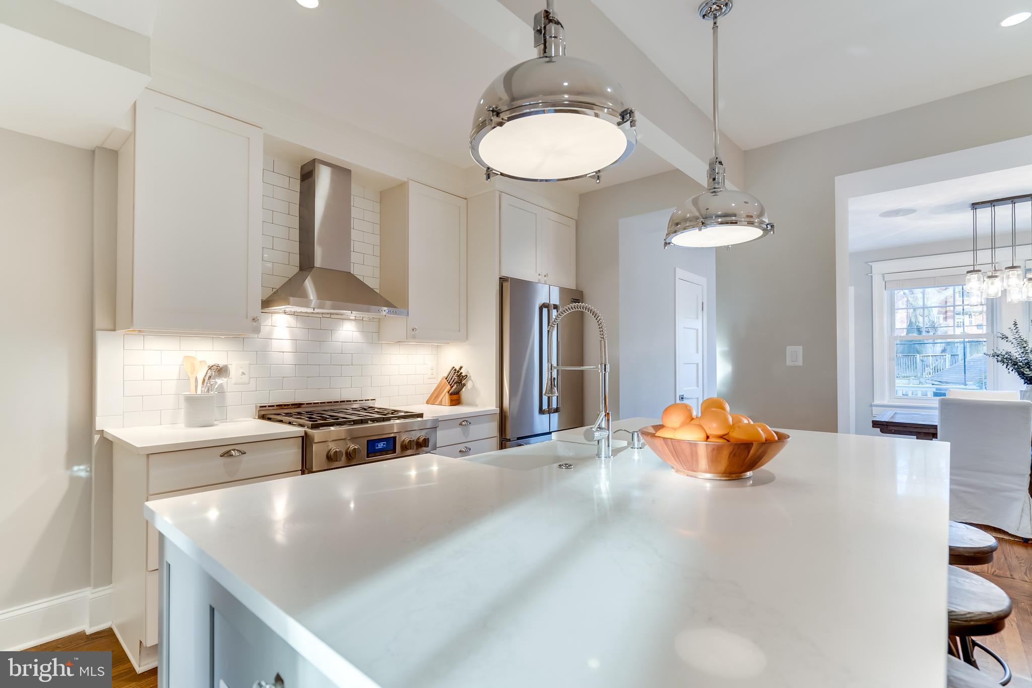 2211 38th Street Northwest Washington, DC 20007 - Photo 10 of 51 a kitchen with stainless steel appliances granite countertop a sink a stove and a refrigerator