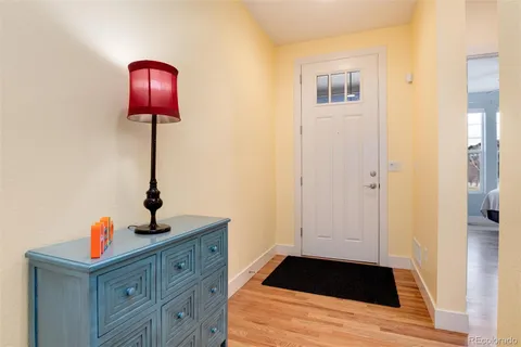 a view of a livingroom with wooden floor and staircase