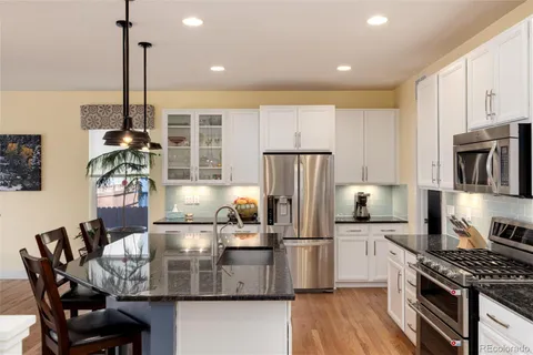 a kitchen with kitchen island a counter top space appliances and cabinets