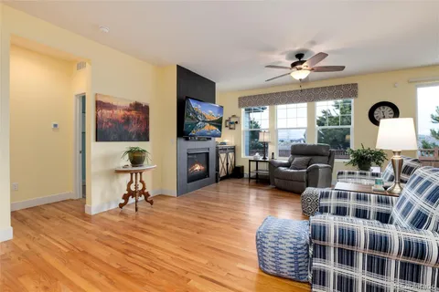 a living room with furniture a rug and a flat screen tv